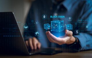 Businessman using a computer and blockchain icon in hand