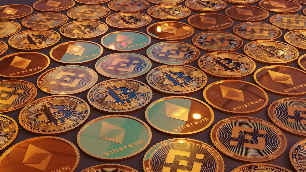 Various types of cryptocurrencies laid out on a table