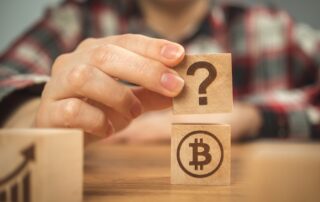 A man stacking a question mark block on top of a Bitcoin block